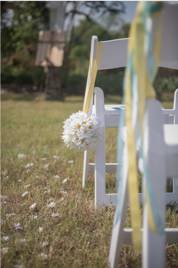 Hand placed daisies for aisle runner